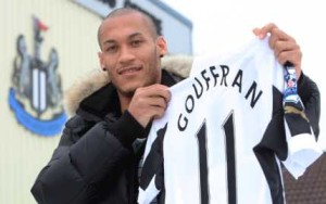 Gouffran holds up his new shirt