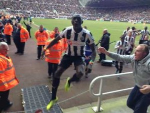 Cisse prepares to leap into the crowd following his winner